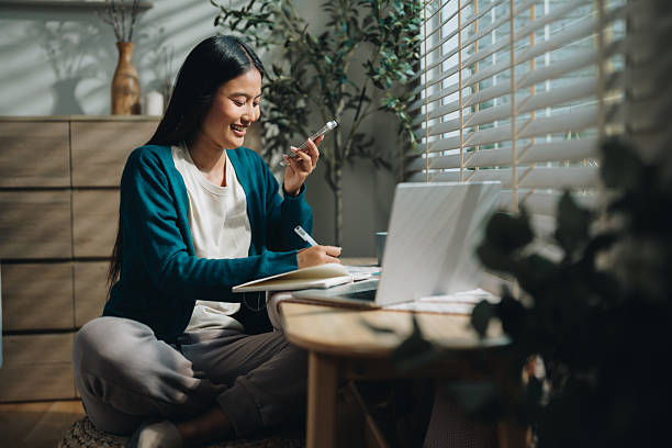 Woman using a language app on her phone, enthusiastically learning a new foreign language Woman using a language app on her phone, enthusiastically learning a new foreign language, immersed in the interactive lessons, she embraces the joy of expanding her linguistic skills, gaining confidence with every practice session online education stock pictures, royalty-free photos & images