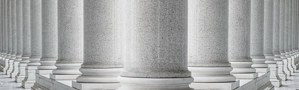 istock White marble columns in a neoclassical architectural style. Symmetrical row of classical marble columns, structural repetition, and elegant monumental design 2223784005