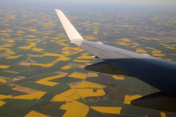 Natural background of sky view with clouds from above of airplane and airplane wings seen.