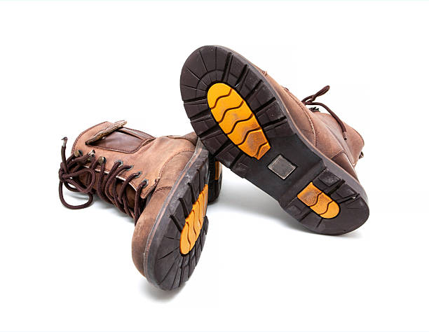 close-up wide angle view of new boots mini lugs black rubber outsole with 120 plus oil resistance grade , isolated on white background