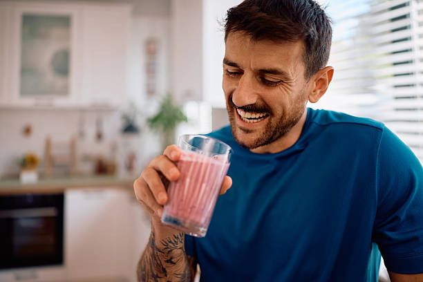 istock Happy man enjoying in the morning while drinking smoothie at home. 2223786154