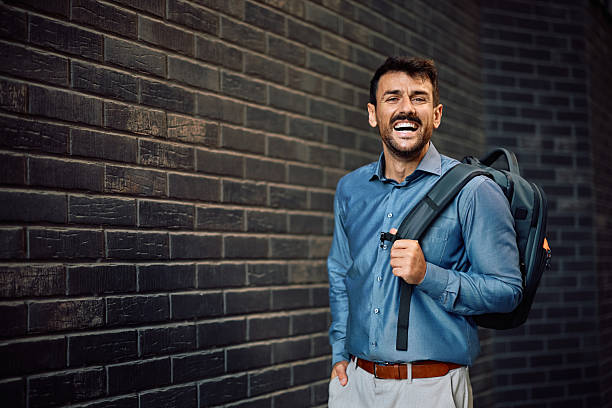 istock Happy entrepreneur by a brick wall looking at camera. 2223787791
