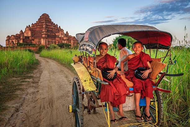 istock Young Buddhist monks on the horse cart 2223788952