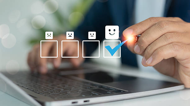 istock Close-up of hand selecting happy face icon with blue check mark on digital feedback survey, representing customer satisfaction and user experience rating. 2223788991