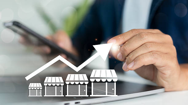 istock Close-up of a hand using a smartphone with increasing store graph icons, representing franchise business growth, retail expansion, and multi-location store strategy. 2223789010