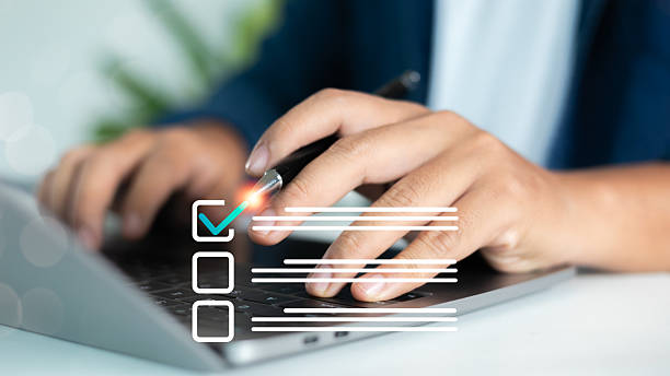 istock Close-up of a hand checking task on a digital checklist using a laptop, representing online task management, productivity tools, and business planning workflow. 2223789018