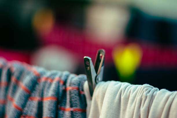 Colorful clothes hanging on a clothesline, drying under natural sunlight.