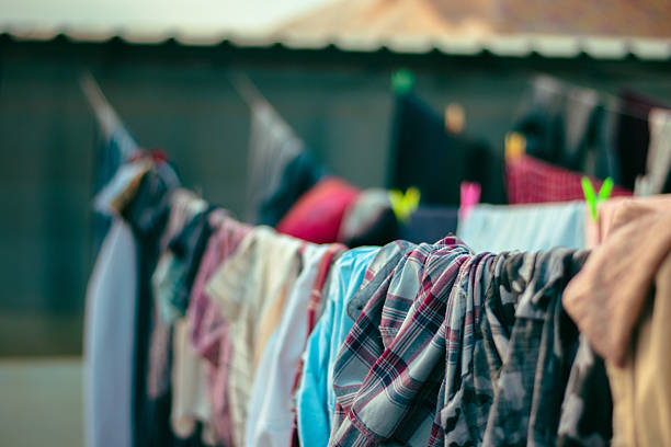 Colorful clothes hanging on a clothesline, drying under natural sunlight.