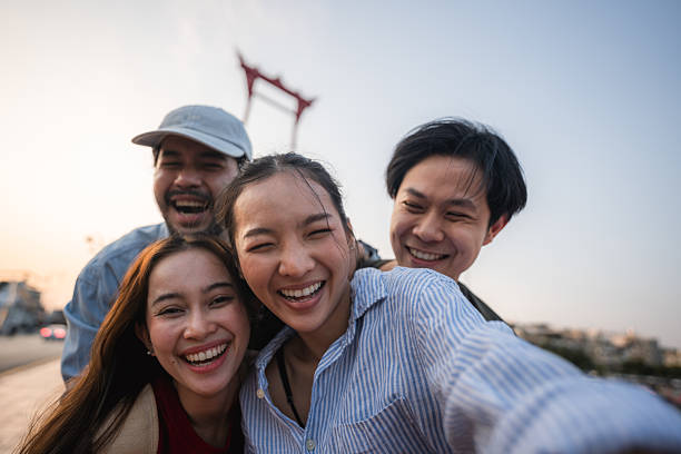 istock Group of friends taking pictures and filming themselves with digital camera while exploring the city of Bangkok 2223799675