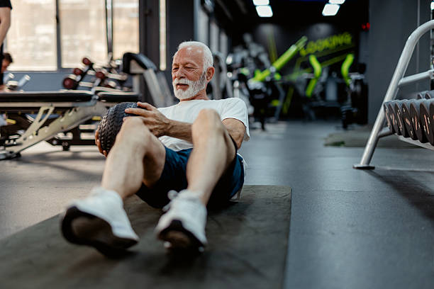 istock Athletic Elderly Male Doing Core Workout With Medicine Ball 2223799887