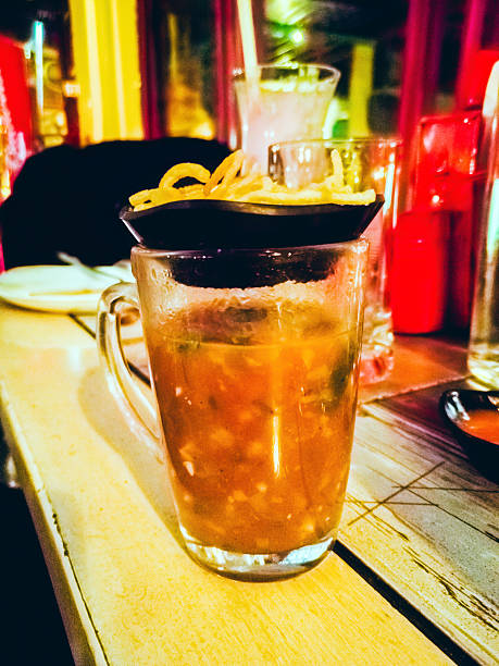 Chicken soup with crispy noodles in a glass mug
