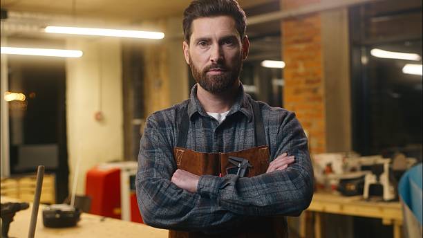 istock Confident Caucasian man carpenter crossing arms posing in workshop serious wood master builder male small business designer guy constructor working carpentry job artwork craftsmanship artist woodwork 2223800593