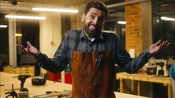 Confused Caucasian wood master man shrugging shoulders doubt gesture in workshop small business male artist designer incertitude woodworker craftsman hesitate guy uncertain feedback difficult question