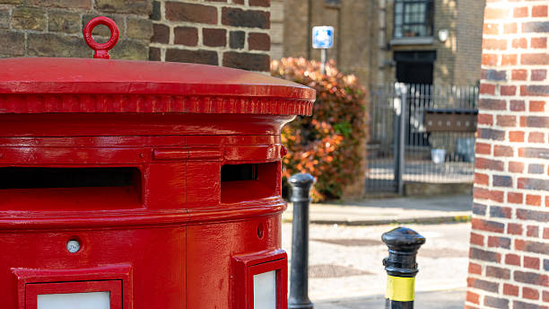 istock Traditional red Royal Mail postbox on brick street in UK 2223801072