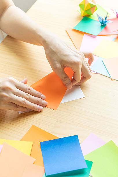 istock Origami. Woman's hands folding origami. 2223801269