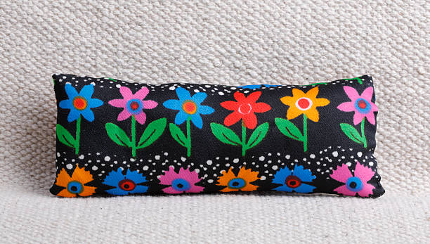 Black cushion with colorful flowers on sofa