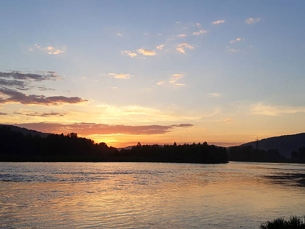 Sunset over the forest river. Beautiful sunset over river. River at sunset. Sunset river water.