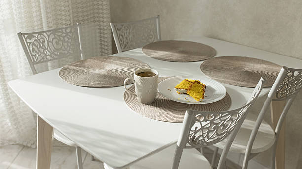Breakfast. Cup of tea on table. Sweet dessert on a plate