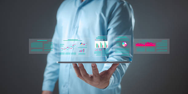 istock Person holds tablet displaying data dashboards with various charts and graphs. Business intelligence, financial analysis, data analytics, digital reporting. Corporate strategy and tech concepts. 2223804228
