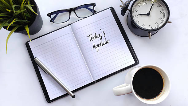istock Today's Agenda Notebook, Coffee, Alarm Clock, and Eyeglasses on White Background 2223807466