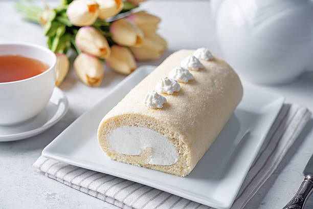 istock Vanilla cake roll with whipped cream filling in a plate 2223813934