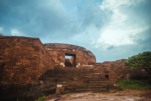 Ancient dome-shaped stone monument with weathered steps in Badami, Karnataka, India.