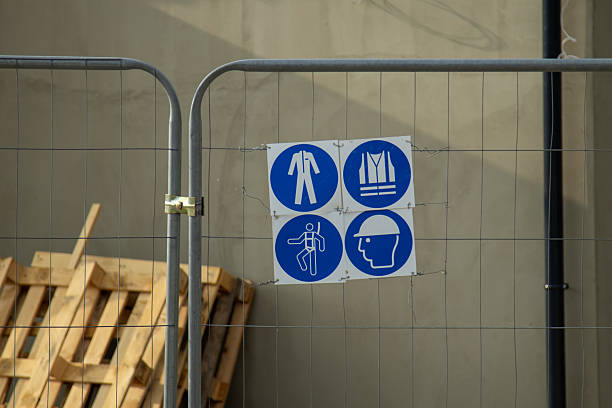 istock Blue safety signs on a construction fence indicate required protective equipment 2223816345