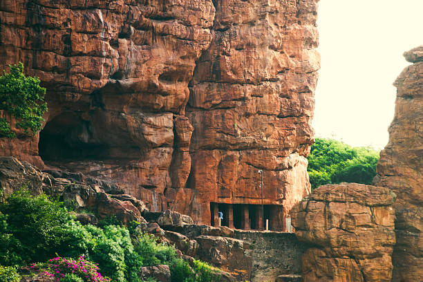 Badami cave temple nestled in red sandstone cliffs.