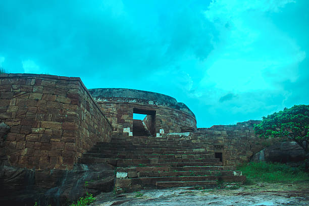 Ancient dome-shaped stone monument with weathered steps in Badami, Karnataka, India.