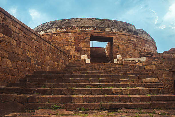 Ancient dome-shaped stone monument with weathered steps in Badami, Karnataka, India.