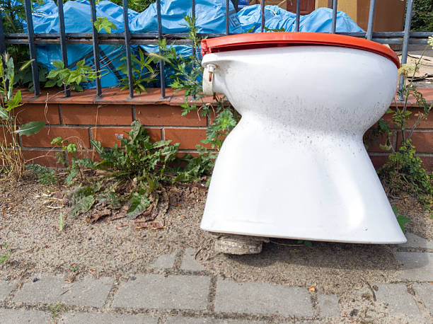 istock Old dirty toilet bowl on sidewalk 2223818494