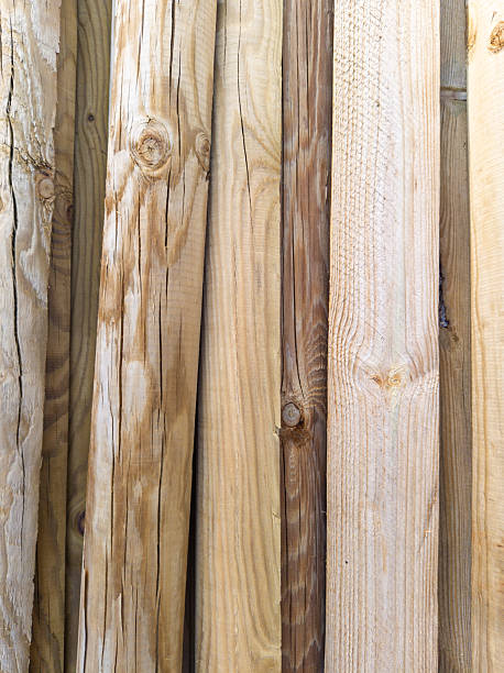 Stacked wooden planks and logs close up
