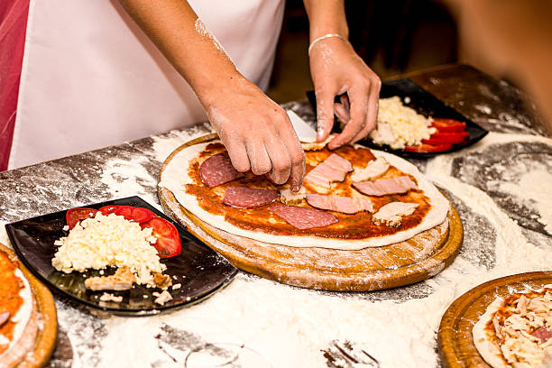 istock Children's hands are making delicious pizza 2223819347