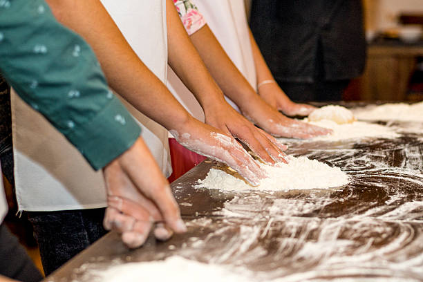 istock Women's hands smeared in flour and flour on the table 2223819444