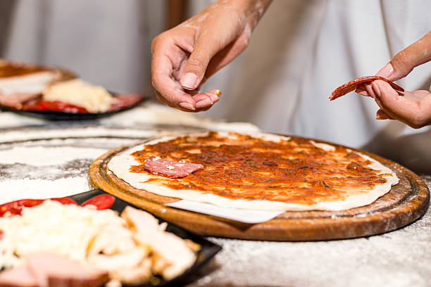 istock Children's hands are making delicious pizza 2223819458