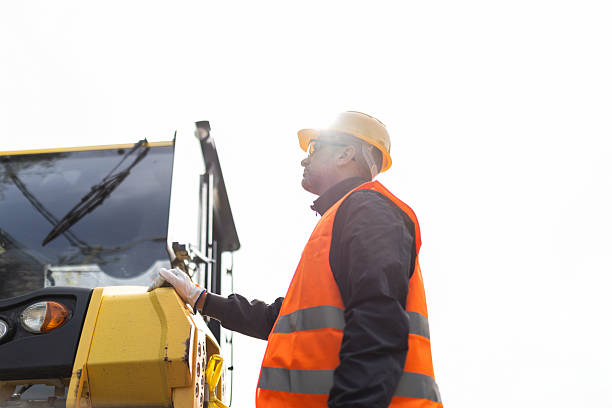 istock Construction worker oversees machinery operation during sunny day at job site 2223819574
