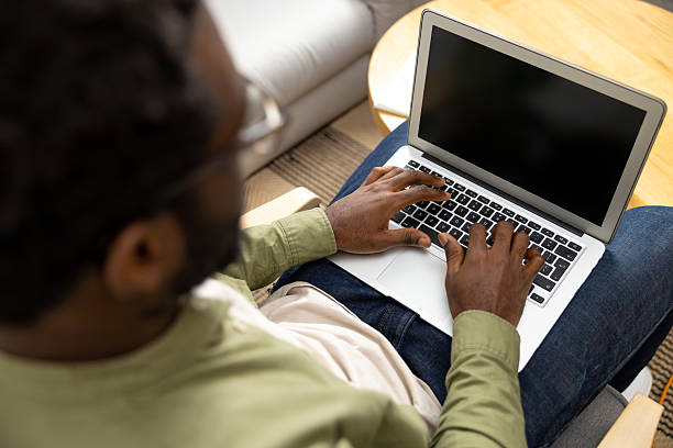istock Curly-haired african american young man working online from home 2223822823