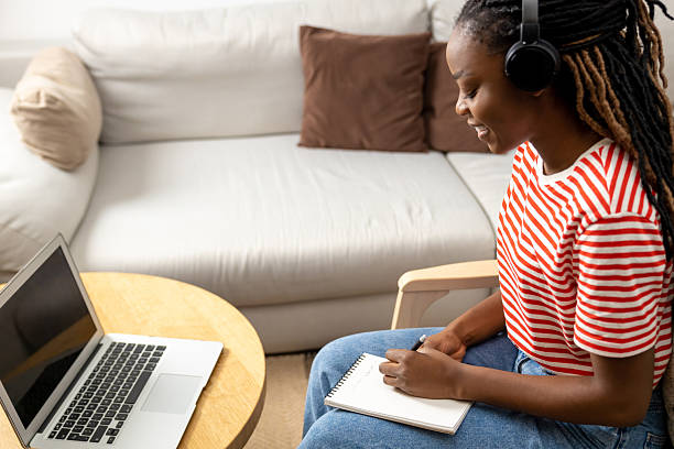 istock Cute young dark-skinned young woman having online lecture and looking involved 2223822870