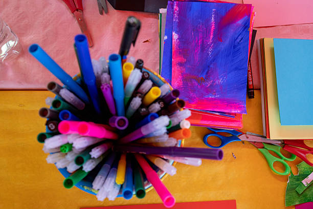 Colourful pensils and colour papers on the table
