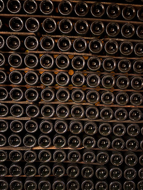 istock Old wine bottles stacked and stored in a cellar for aging 2223825821