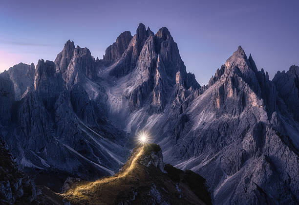 istock Flashlight trails on mountain path against high rocks at night 2223825991