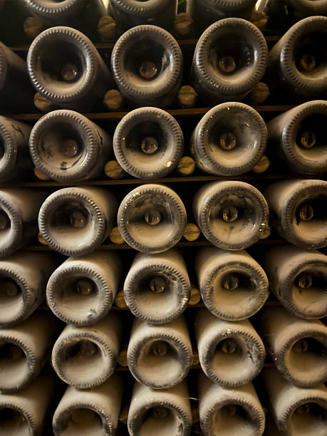 istock Old wine bottles stacked and stored in a cellar for aging 2223826114