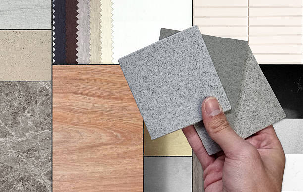 istock interior designer compares quartz stone samples with diverse range of textures: elegant wood, luxurious marble, versatile tiles, stainless and soft fabrics in a sophisticated neutral color scheme. 2223826211