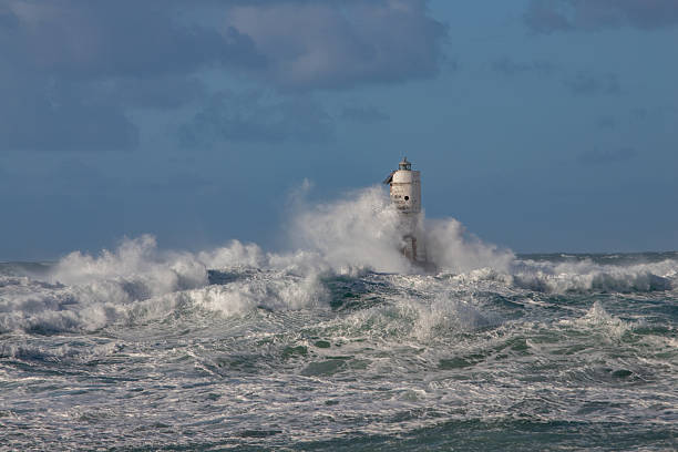 istock Stormy Sea Waves Collide with Coastal Lighthouse 2223829279