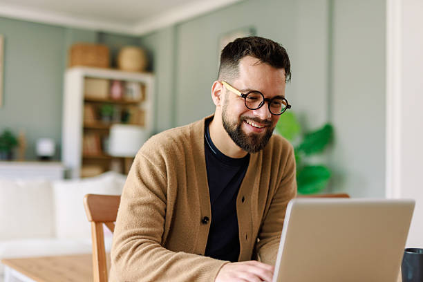 istock Smiling Young Caucasian Man Working from Home in Cozy Living Room Setting 2223829393