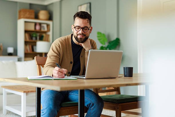 istock Young Caucasian Man Working from Home in Bright Modern Living Space 2223829611