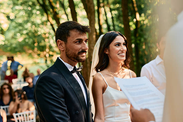 istock Bride and groom exchanging vows during a wedding ceremony in the woods 2223831949