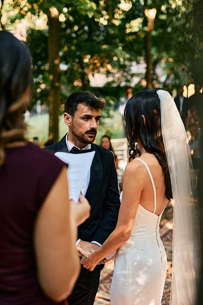 istock Bride and groom exchanging vows during wedding ceremony in a forest 2223832530