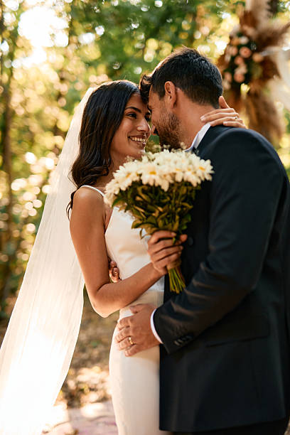 istock Happy couple embracing during wedding ceremony in the forest 2223832902