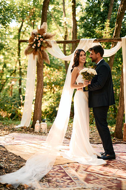 istock Romantic couple getting married during a bohemian forest wedding ceremony 2223832903